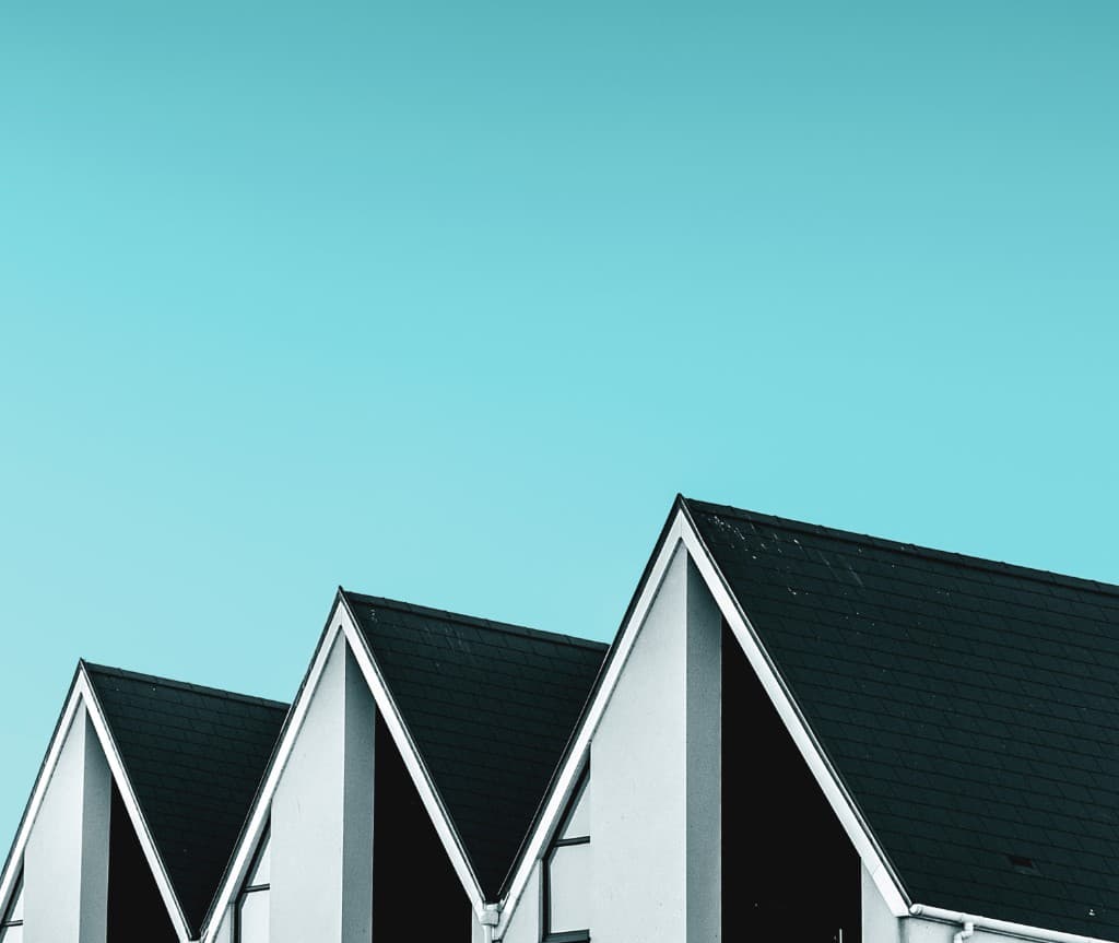 Modern rooftops against a clear blue sky.